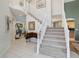 Elegant entryway with a grand staircase and tiled flooring at 22385 E Arbor Pl, Aurora, CO 80016