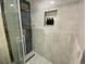 Updated shower with marble tile and gold fixtures at 5405 Saulsbury Ct, Arvada, CO 80002