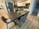 Kitchen dining area with dark wood table and gray chairs at 5405 Saulsbury Ct, Arvada, CO 80002