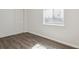 Bedroom with sliding door closet and dark wood laminate flooring at 179 N Prairie Falcon Pkwy, Brighton, CO 80601