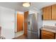 Kitchen with stainless steel refrigerator and wood cabinets at 8971 W Yale Ave, Lakewood, CO 80227