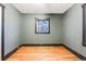 Simple bedroom with hardwood floors and a window at 3603 Meade St, Denver, CO 80211