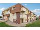 Apartment building exterior with a well-maintained lawn at 10211 Ura Ln # 8-207, Thornton, CO 80260