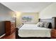 Comfortable bedroom with a queen-size bed and window at 10211 Ura Ln # 8-207, Thornton, CO 80260