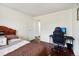 Bedroom with a bed, desk, and access to hall at 10211 Ura Ln # 8-207, Thornton, CO 80260