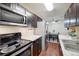 Modern kitchen featuring stainless steel appliances and granite countertops at 10211 Ura Ln # 8-207, Thornton, CO 80260
