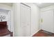 Bright entryway with wood floors, coat closet, and view into adjacent room at 10211 Ura Ln # 8-207, Thornton, CO 80260
