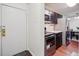 Entryway with door and view into kitchen at 10211 Ura Ln # 8-207, Thornton, CO 80260