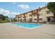 Community pool with apartment building in background at 10211 Ura Ln # 8-207, Thornton, CO 80260