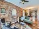 Living room features exposed brick wall, green couch, and hardwood floors at 3960 Kalamath St, Denver, CO 80211