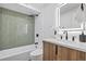 Basement bathroom with modern vanity, green tile, and walk-in shower at 870 S Eaton St, Lakewood, CO 80226