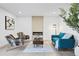 Bright living room featuring a fireplace and stylish mid-century modern furniture at 870 S Eaton St, Lakewood, CO 80226