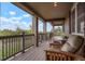 Spacious covered porch with wooden chairs and scenic views at 5410 Columbine Rd, Denver, CO 80221