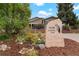 House exterior featuring a landscaped yard and stone address marker at 5410 Columbine Rd, Denver, CO 80221