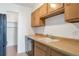 Kitchen with wood cabinets, black appliances and a built-in dishwasher at 4570 E Yale Ave # 702, Denver, CO 80222