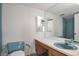 Bathroom with dual sinks, a large mirror, and a shower/tub combo at 4570 E Yale Ave # 702, Denver, CO 80222