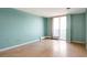 Bedroom with wood floors, light walls, and access to a balcony at 4570 E Yale Ave # 702, Denver, CO 80222