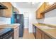 View of kitchen with wood cabinets, black appliances, and a pantry at 4570 E Yale Ave # 702, Denver, CO 80222