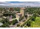 Wide aerial view of the condo building, city skyline, and golf course at 25 N Downing St # 2-304, Denver, CO 80218