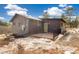 Log cabin home exterior with deck and mountain views in background at 18810 Cloven Hoof Rd, Palmer Lake, CO 80133