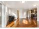 Living room with hardwood floors, access to deck, and kitchen view at 18810 Cloven Hoof Rd, Palmer Lake, CO 80133