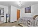 Bright basement bedroom featuring a comfortable bed and built-in shelving at 7050 Alan Dr, Denver, CO 80221