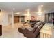 Finished basement with leather sectional sofa and built-in shelving at 114 E 14Th Ct, Broomfield, CO 80020