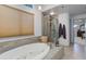 Relaxing bathroom with soaking tub, shower, and tile flooring at 114 E 14Th Ct, Broomfield, CO 80020
