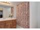 Clean bathroom with floral shower curtain, vanity, and bathtub at 114 E 14Th Ct, Broomfield, CO 80020