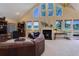 Spacious living room with vaulted ceilings, fireplace, and ample natural light at 114 E 14Th Ct, Broomfield, CO 80020