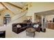 Open concept living room with curved sectional sofa and views into kitchen at 114 E 14Th Ct, Broomfield, CO 80020