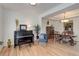 Living room with hardwood floors, piano, and views into dining area at 114 E 14Th Ct, Broomfield, CO 80020