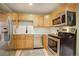 Modern kitchen with stainless steel appliances and light wood cabinets at 1050 N Lafayette St # 408, Denver, CO 80218