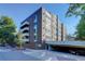 Full view of Majorca Condominiums building, including parking area at 1050 N Lafayette St # 408, Denver, CO 80218