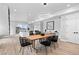 Bright dining area with a wood table and black chairs, adjacent to the living room at 3495 Lipan St, Denver, CO 80211