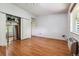 Bedroom with mirrored closet doors and hardwood floor at 9385 E Center Ave # 1D, Denver, CO 80247