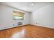 Spacious bedroom with hardwood floors and window at 9385 E Center Ave # 1D, Denver, CO 80247