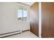 Simple hallway with tile flooring, a window, and access to other rooms at 9385 E Center Ave # 1D, Denver, CO 80247