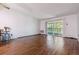 Living room with sliding door to patio and hardwood floors at 9385 E Center Ave # 1D, Denver, CO 80247