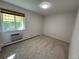 Bright bedroom with carpeted floors and a window offering natural light at 9385 E Center Ave # 1D, Denver, CO 80247
