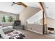 Open loft living area with large windows and vaulted ceiling, showcasing natural light at 12171 S Critchell Ln, Littleton, CO 80127