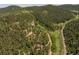 Aerial view showcasing a house amongst trees and neighboring properties at 12171 S Critchell Ln, Littleton, CO 80127