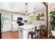 Updated kitchen featuring white cabinets and breakfast bar at 12171 S Critchell Ln, Littleton, CO 80127