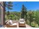 Deck with wicker chairs offering mountain views at 12171 S Critchell Ln, Littleton, CO 80127
