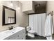 Bathroom with updated vanity, white fixtures, and a shower/tub at 12171 S Critchell Ln, Littleton, CO 80127