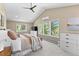 Spacious primary bedroom features large windows, a comfortable bed, and ample natural light at 12171 S Critchell Ln, Littleton, CO 80127