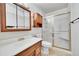 Bathroom with shower, vanity, and mirrored medicine cabinet at 12102 E Hawaii Dr, Aurora, CO 80012