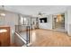 Living room with hardwood floors, ceiling fan, and large TV at 12102 E Hawaii Dr, Aurora, CO 80012