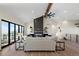 Bright living room features a modern fireplace and access to a deck with scenic views at 44035 Pony Express Ct, Elizabeth, CO 80107