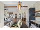 Open concept dining room with modern chandelier and view into spacious living area at 44035 Pony Express Ct, Elizabeth, CO 80107